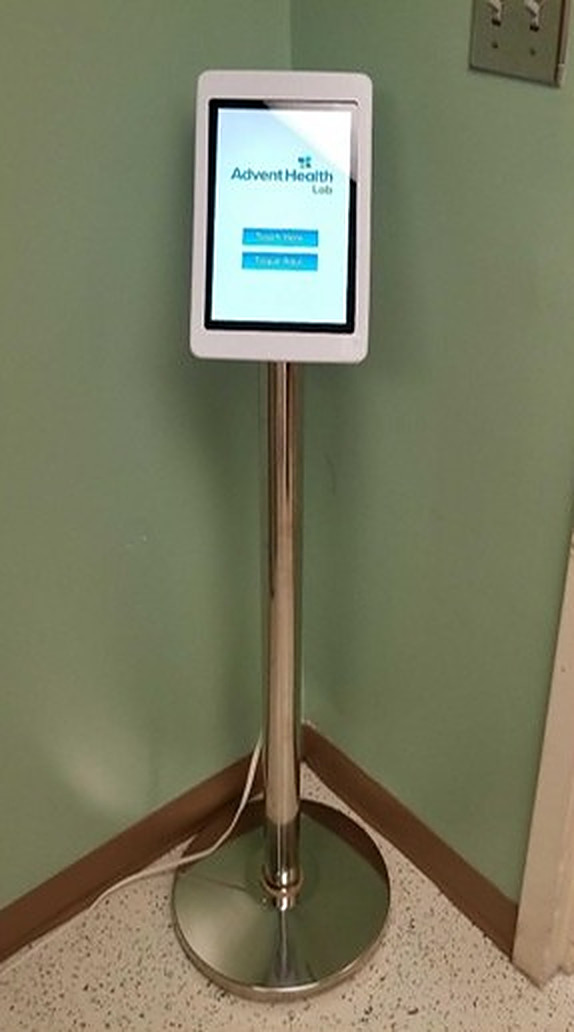 AdventHealth Lab survey tablet kiosk on a chrome floor stand