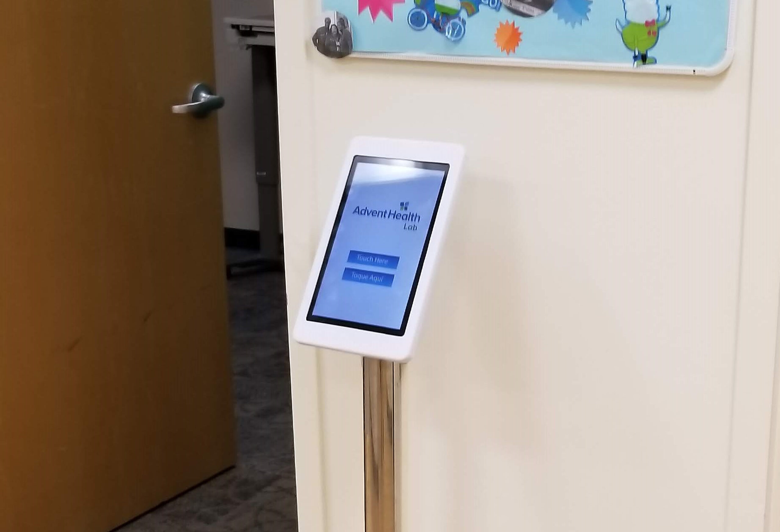 AdventHealth Lab survey tablet kiosk on a chrome floor stand